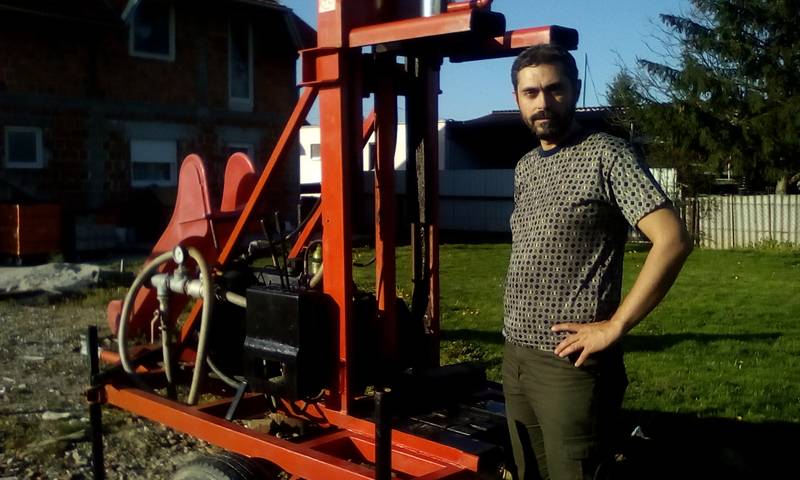 Mr. Jean Louis in front of a water well drilling rig