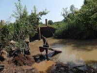 Person processing soil on the river Okame in Uganda