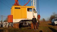 Jean Louis in front of the dragline excavator and crane