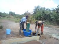Mr. Okedi and Mr. Wabwire collecting the gold concentrate in Uganda