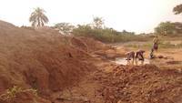 Women and people panning for gold nearby our tailings heaps