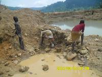 Children washing surplus ore for gold