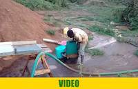 Mr. Okedi collecting concentrates from looped carpets