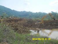 Miner panning for gold in the dam in Ghana